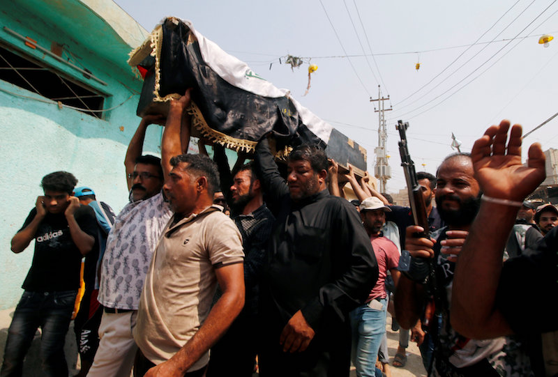 Mourners carry the coffin of a protester