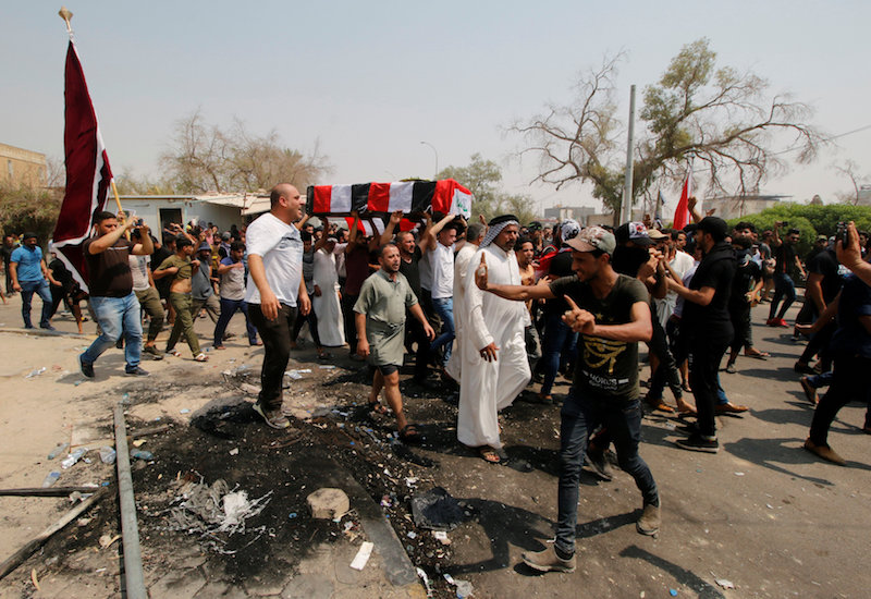 Mourners carry the coffin of a protester