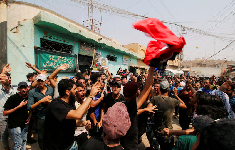 Mourners gather during a funeral