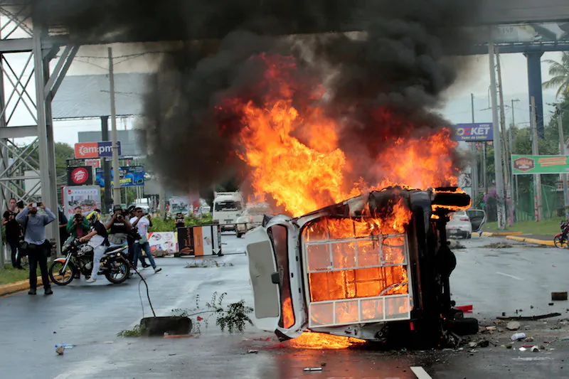 File photo: People take pictures of a burning police car during a protest against Nicaraguan President Daniel Ortega's government in Managua, Nicaragua September 2, 2018. (Reuters/Oswaldo Rivas/File Photo)