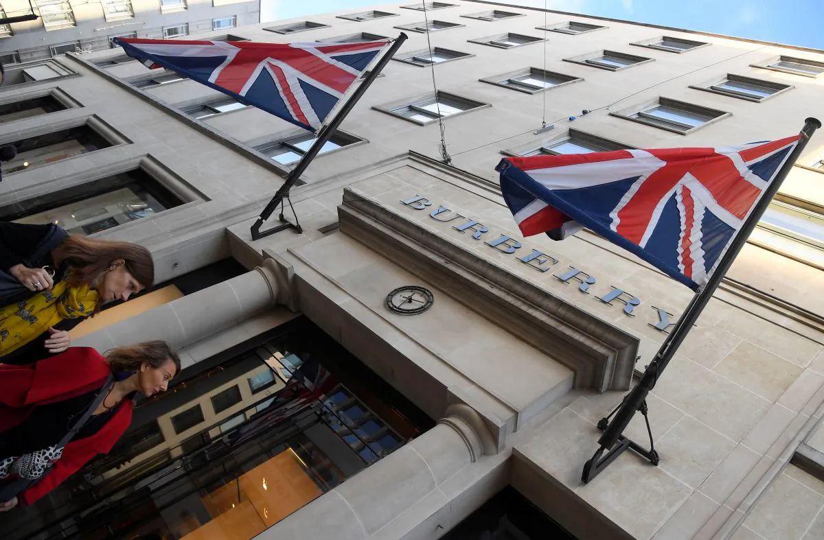 Shoppers walk past a Burberry store in central London, on Nov. 3, 2017. (Reuters/Toby Melville)