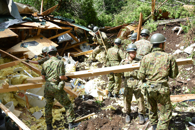 Men search for survivors after Japan Quake