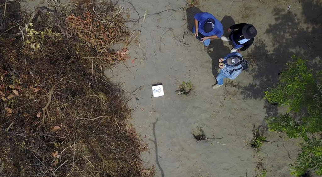 workers at clandestine mass grave