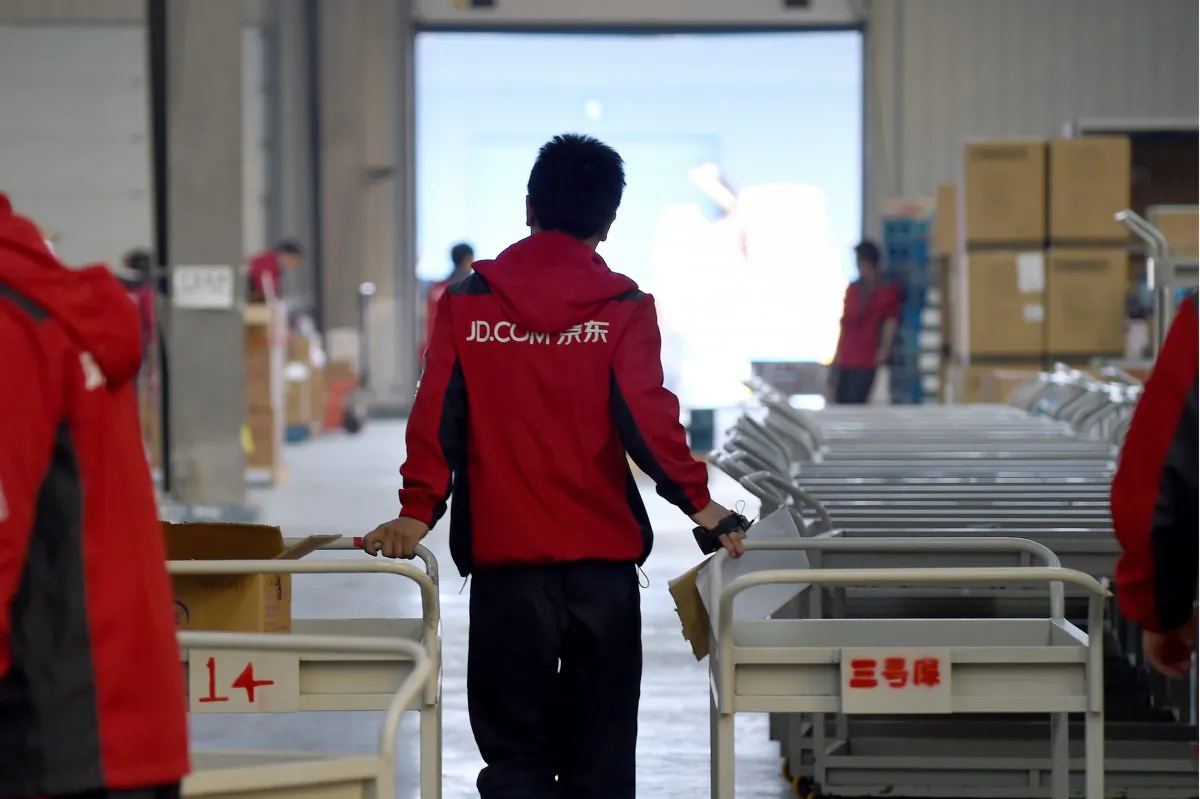 A worker at online retailer JD.com pulling a trolley at a warehouse in Langfang City, Hebei Province, on Nov. 3, 2015. (Wang Zhao/AFP/Getty Images)