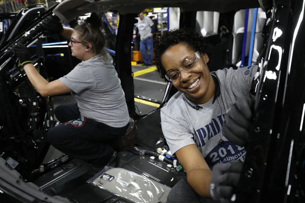 Ford workers Jasmine Powers (right) and Cassie Bell (left), both of Louisville, Kentucky, install visors into the 2018 Ford Expedition SUV as it goes through the assembly line at the Ford Kentucky Truck Plant in Louisville, Kentucky in Oct. 27, 2017. (Bill Pugliano/Getty Images)
