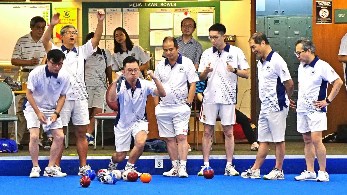In the first game of the second half of the Premier League season, the two HK Football Club teams in first division played against each other.  The leader HKFC-A won their “away” game 2-6 and opened the gap to 10 points at the top.  Photo shows HKFC-A bowler Terry Kung (third from left) excitingly celebrating a great shot from his skip Terry Cheung (not in photo) when their team came from behind to beat their clubmates. (Mike Worth)