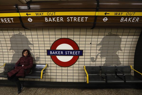 A passengers waits at Baker Street