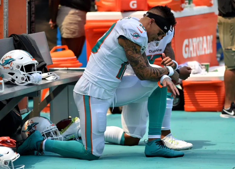 Miami Dolphins wide receiver Kenny Stills (left) and Dolphins wide receiver Albert Wilson (right) both kneel during the national anthem prior to a game against the Tennessee Titans at Hard Rock Stadium. Mandatory Credit: Steve Mitchell-USA TODAY Sports