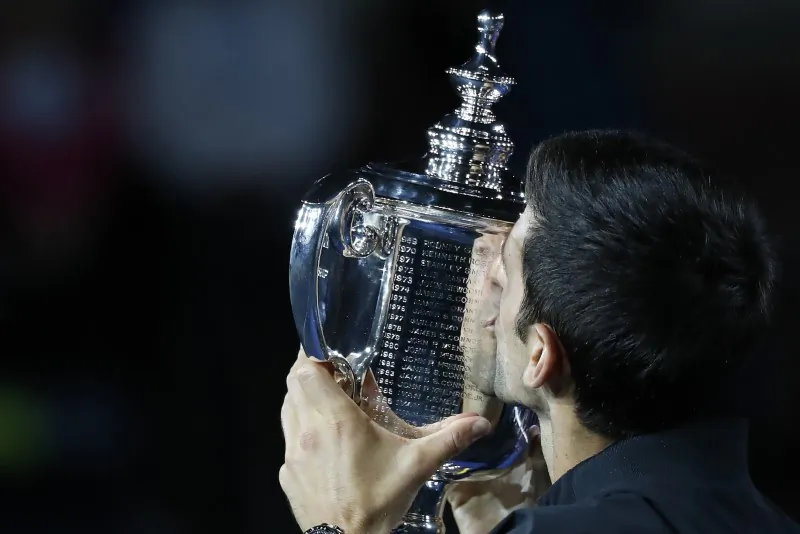 Novak Djokovic of Serbia kisses the championship trophy after his match against Juan Mart’n Del Potro of Argentina in the men's final in the 2018 U.S. Open tennis tournament. (Geoff Burke-USA TODAY Sports)