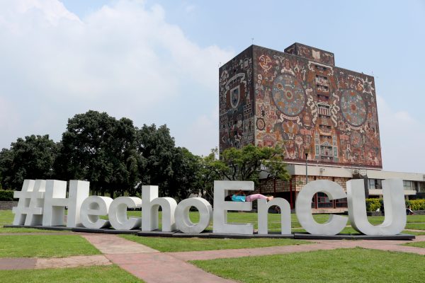 A young girl rests on a “Made in CU” (Ciudad Universitaria) in the shadow of the Biblioteca Central on Sept. 7, 2018 amid the calm of UNAM's main campus just two days after a protest against the university's authorities drew 30,000 people. (Tim MacFarlan/Special to The Epoch Times)