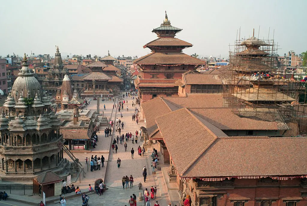 Nepalese workers restore a temple (R) in Durbar Square in Patan, south of Kathmandu, Nepal, on April 10, 2016. (Matthieu Alexandre/AFP/Getty Images)