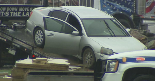 A car is pulled onto a truck after being swept into a culvert in Fort Worth, killing it's occupants, on Sept 8, 2018. (Screenshot/Fox News)