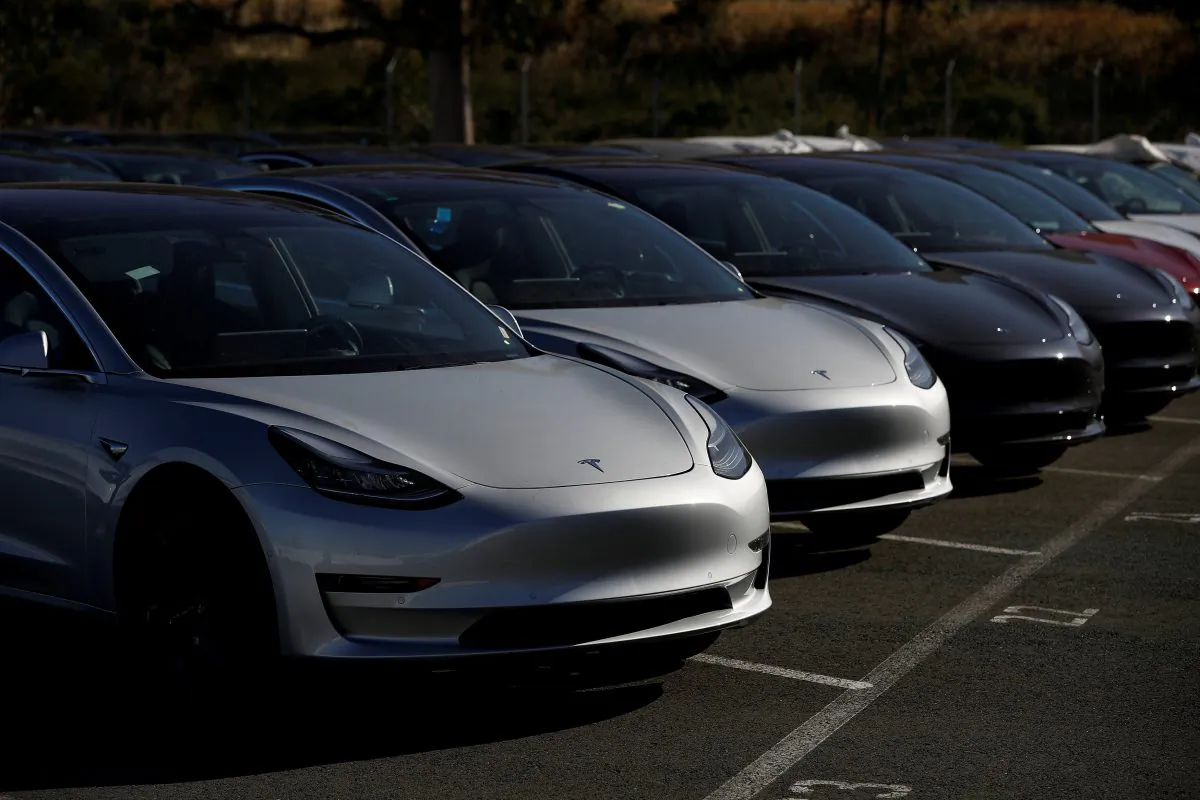 A row of new Tesla Model 3 electric vehicles is seen at a parking lot in Richmond, Calif., on June 22, 2018. (Stephen Lam/Reuters)