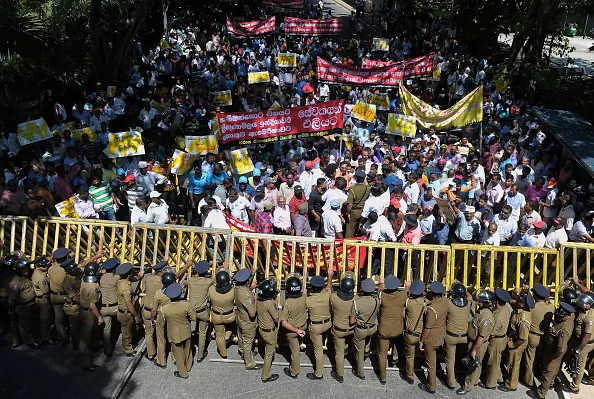Sri Lankan police stand guard during a protest against the proposed sale of a stake in a loss-making port to a Chinese company in Colombo on February 1, 2017. (ISHARA S. KODIKARA/AFP/Getty Images)