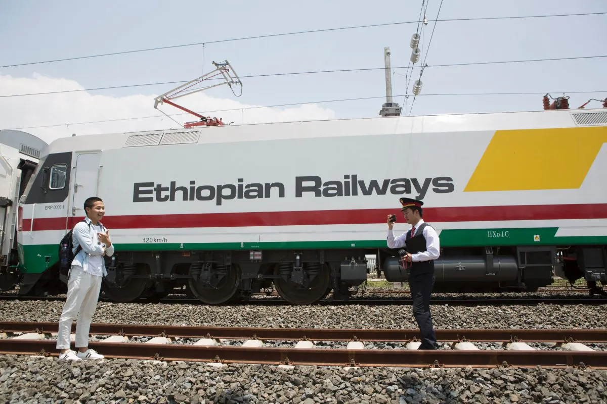 Chinese employees of the new railway which will link Addis Ababa to Djibouti take pictures in front of the Chinese-made Ethiopian trains in Addis Ababa, Ethiopia, on Sep. 24, 2016.
(ZACHARIAS ABUBEKER/AFP/Getty Images)