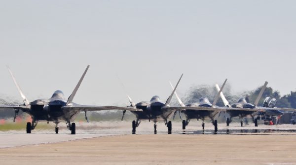 F-22s taxi down runway