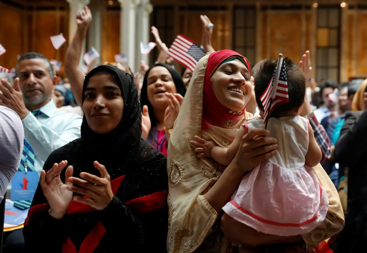 New citizens smile at a U.S. Citizenship and Immigration Services (USCIS) naturalization ceremony at the New York Public Library in Manhattan, N.Y., on July 3, 2018.  (Shannon Stapleton /Reuters)