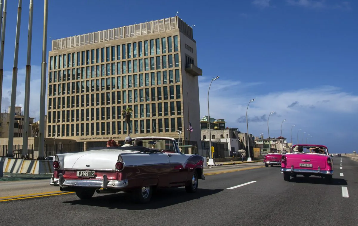 Tourists ride classic convertible cars on the Malecon beside the United States Embassy in Havana, Cuba, on Oct. 3, 2017. (Desmond Boylan/AP Photo)