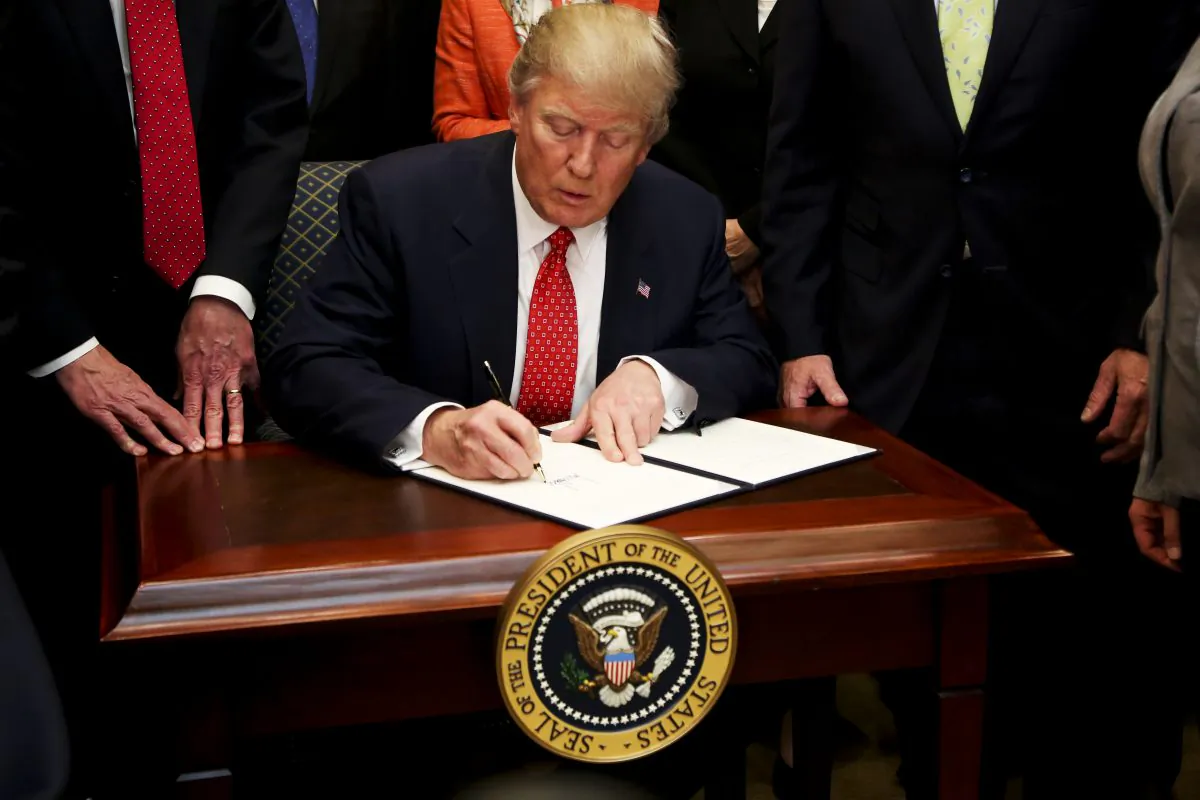 President Donald Trump signs an Executive Order calling for the review of the Waters of the United States Rule, in the Roosevelt Room of the White House in Washington on Feb. 28, 2017. (Aude Guerrucci-Pool/Getty Images)