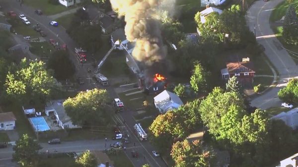 Firefighters battle a raging house fire