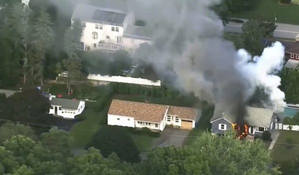 Flames rise from a house
