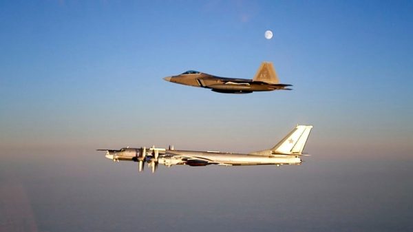 An F-22 Raptor escorts a Russian TU-95 Bear