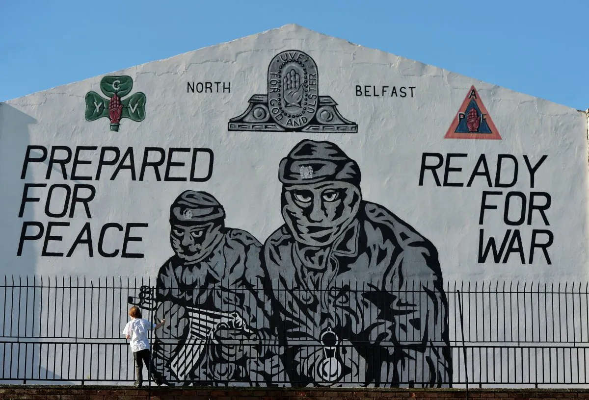 A young boy plays near a loyalist paramilitary mural on the day that the new Loyalist Community Council was launched at the Park Avenue Hotel, in Belfast, Northern Ireland, on Oct. 13, 2015. (Charles McQuillan/Getty Images)