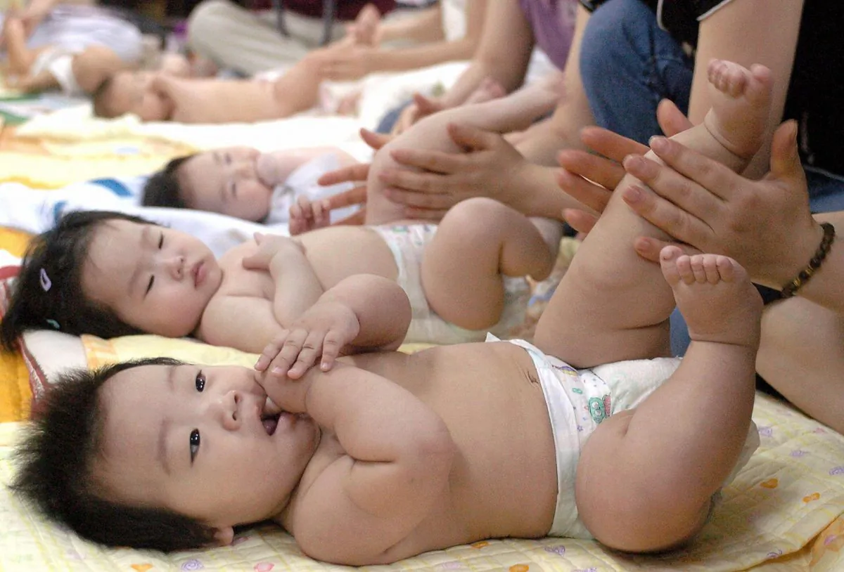South Korean mothers practice massaging their babies during a training program at a public health center in Seoul in this file photo. (Kim Jae-Hwan/AFP/Getty Images)