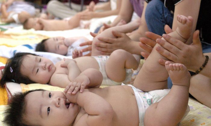 South Korean mothers practice massaging their babies during a training program at a public health center in Seoul in this file photo. (Kim Jae-Hwan/AFP/Getty Images)