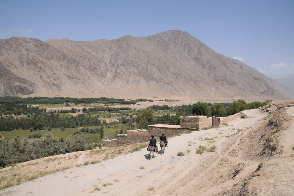 The front between government-held Bahorak and Taliban-controlled Warduj in Badakhshan province, Afghanistan, on Aug. 25, 2018. The bend on the dusty road (centre, right) and the white house (centre) at the foot of the mountain, roughly mark,where Taliban territory begins. (Franz J. Marty/Special to The Epoch Times)