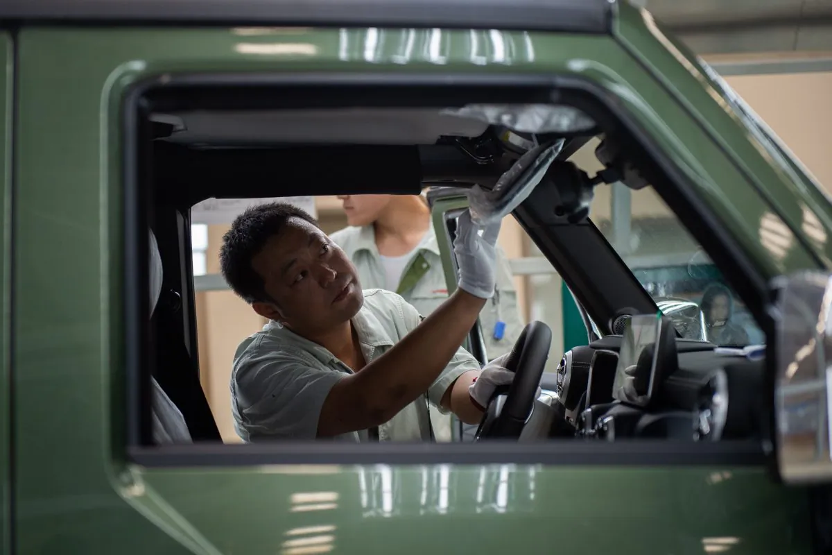 A worker on an car production line is seen at the BAIC (Beijing Automotive Group Co.) assembly plant in Beijing, on Aug. 29. (Nicolas Asfouri/AFP/Getty Images)
