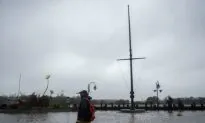 Weatherman Dramatically Braces for Hurricane Florence While Two People Stroll By
