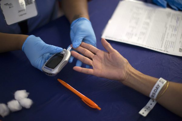 FILE PHOTO - A person receives a test for diabetes during Care Harbor LA free medical clinic in Los Angeles, California September 11, 2014. REUTERS/Mario Anzuoni