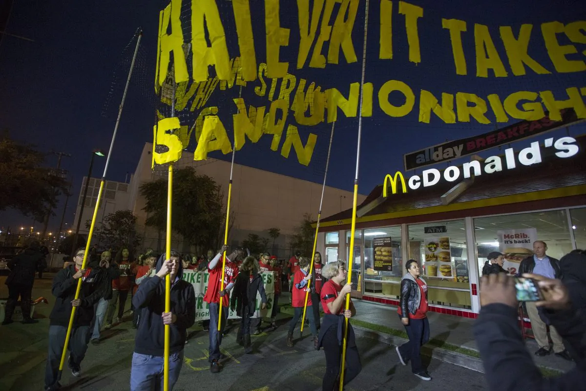 McDonald's restaurant employees rally after walking off the job to demand a $15 per hour wage and union rights in Los Angeles on Nov. 29, 2016. (David McNew/Getty Images)