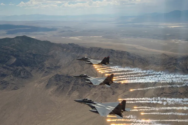 Three U.S. Air Force F-15E Strike Eagles, from Mountain Home Air Force Base, Idaho, fire flares over the Utah Test and Training Range, west of Salt Lake CIty in Utah, July 3, 2018. (U.S. Air Force Airman 1st Class Codie Trimble/Reuters)