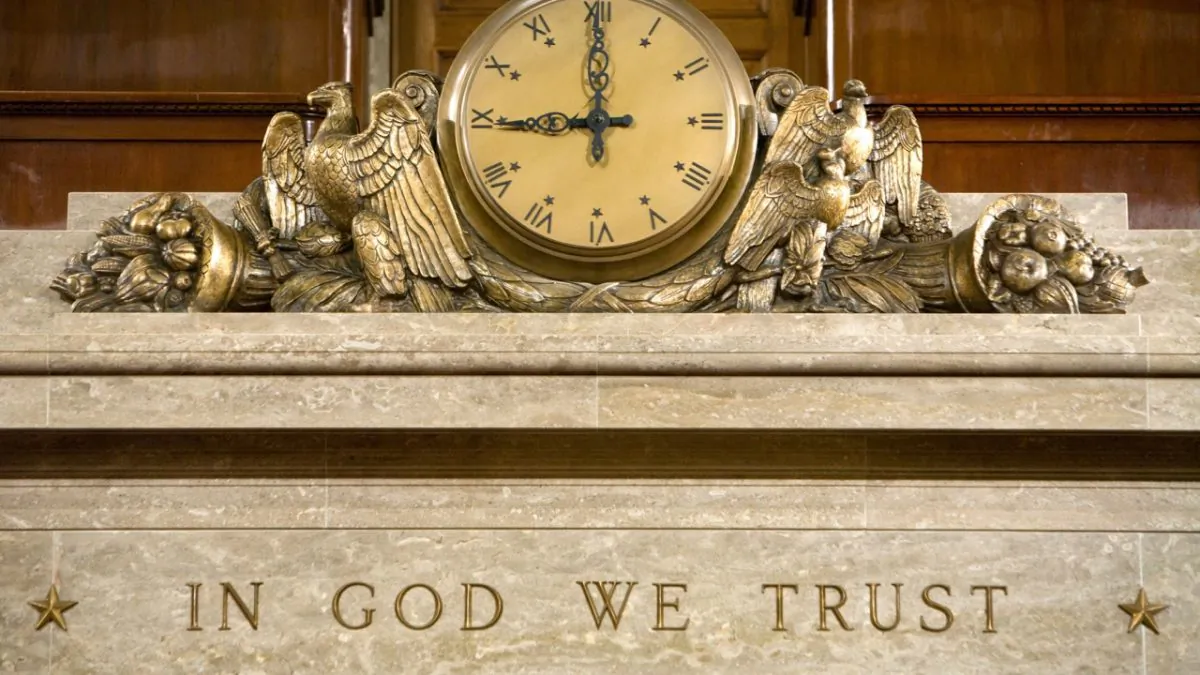 A clock and the motto "In God We Trust" over the Speaker's rostrum in the U.S. House of Representatives chamber in Washington on Dec. 8, 2008. (Brendan Hoffman/Getty Images)