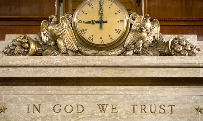 A clock and the motto "In God We Trust" over the Speaker's rostrum in the U.S. House of Representatives chamber in Washington on Dec. 8, 2008. (Brendan Hoffman/Getty Images)