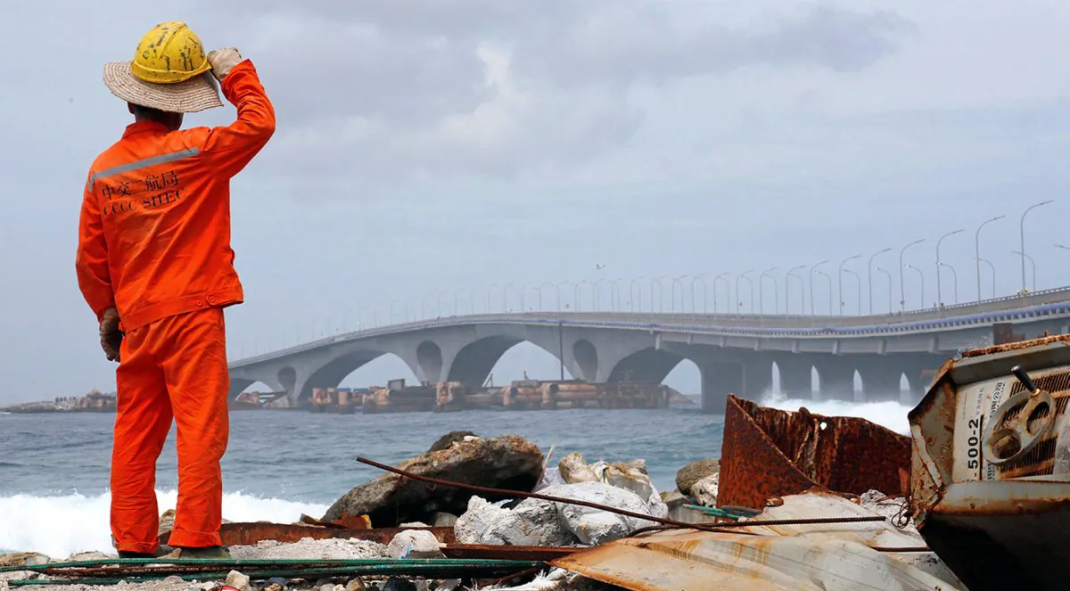 A construction worker looks on as the China-funded Sinamale bridge is seen in Male, Maldives on Sept. 18, 2018. (Ashwa Faheem/Reuters)