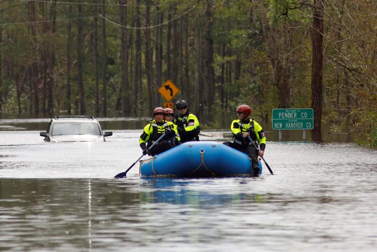 A search and rescue task force patrols a flooded region by boat over a fully submerged road in the aftermath of Hurricane Florence in Castle Hayne, North Carolina, U.S., September 17, 2018. (By Jonathan Drake/Reuters)