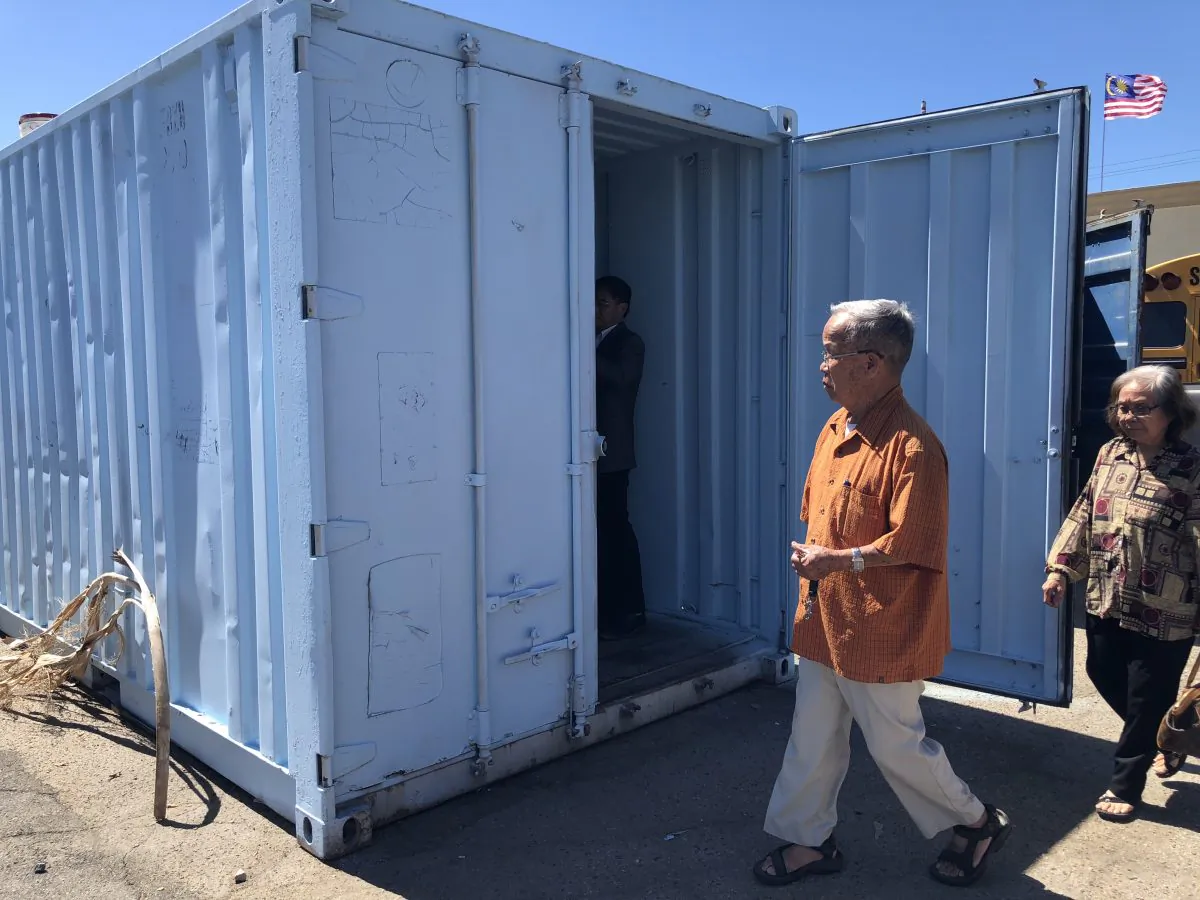 Visitors look at an in-progress shipping container with showers in Garden Grove, Calif. on Sept. 16, 2018. (Annie Wang/Epoch Times)