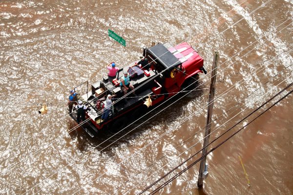 People gather on a truck in floodwater