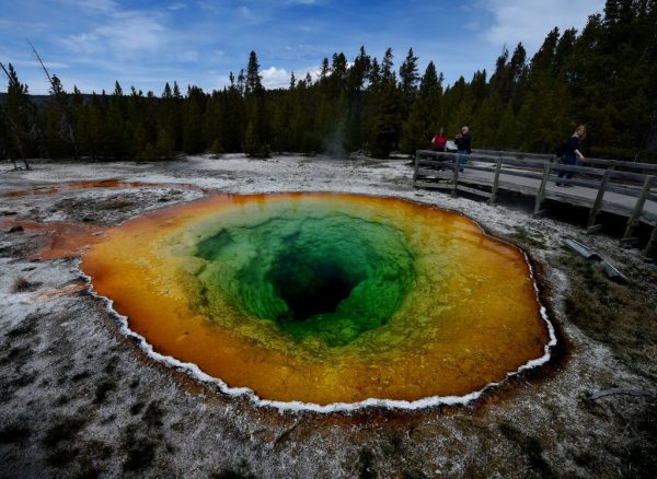 Tourists view the Morning Glory hot spring in the Upper Geyser Basin of Yellowstone National Park in Wyoming, on May 14, 2016. (MARK RALSTON/AFP/Getty Images)