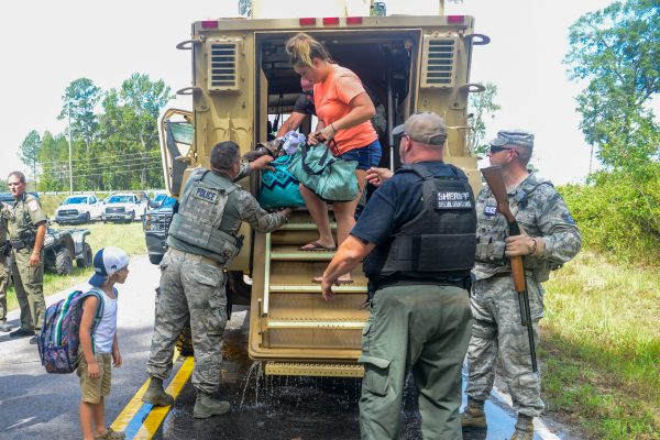 Relief crews help a person off a truck