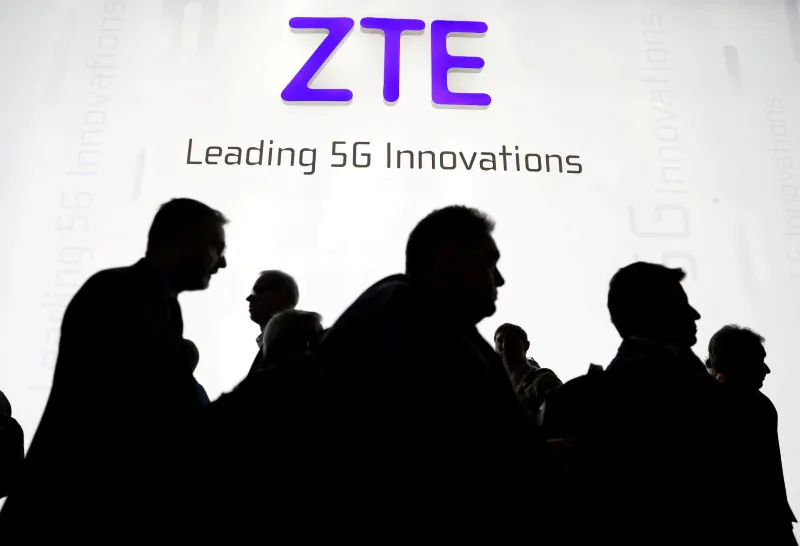 Visitors pass in front of the ZTE Corp booth at the Mobile World Congress in Barcelona, Spain on February 26, 2018. (Sergio Perez/Reuters)