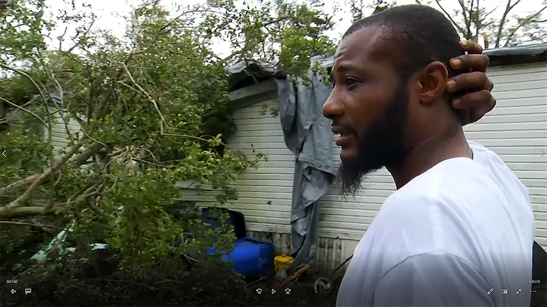 Michael White surveys the hurricane damage