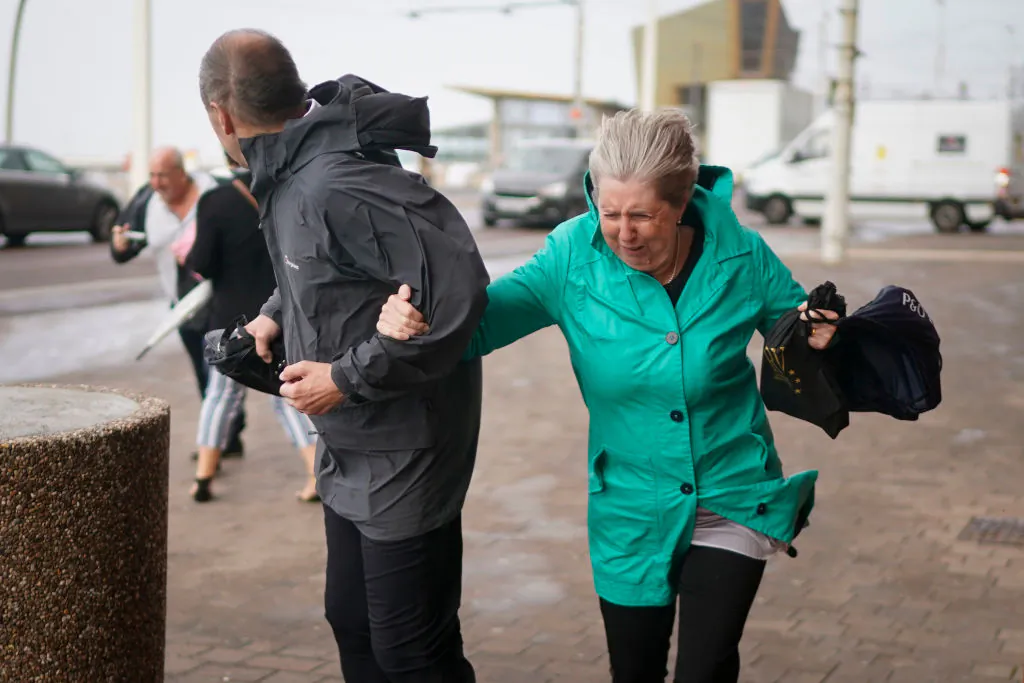 People struggle in the wind as Storm Ali hits land on Sept. 19, 2018, in Blackpool, northern England. (Christopher Furlong/Getty Images)