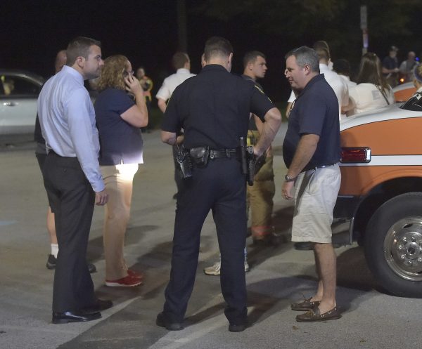 Police talk to family at the crime scene
