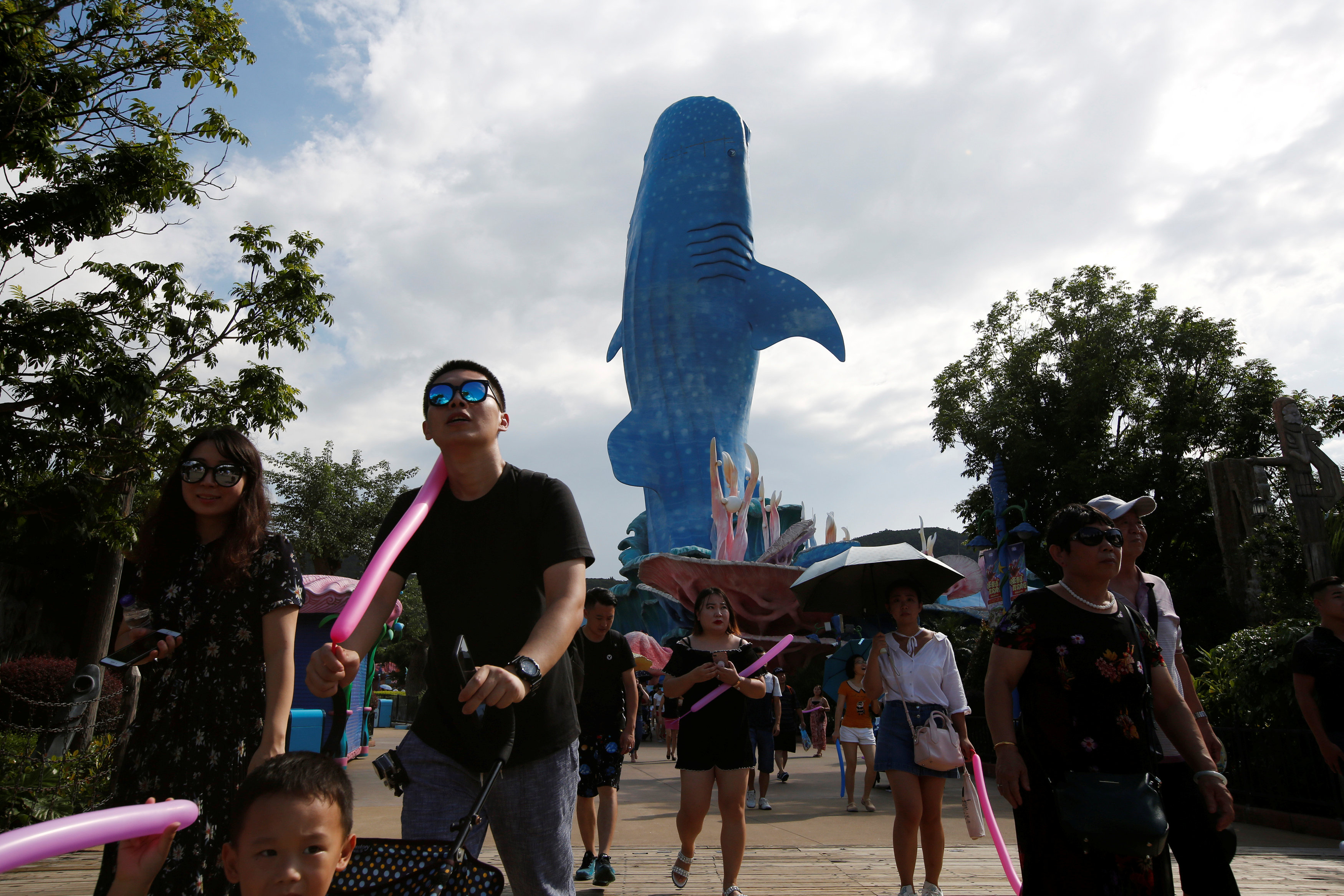 Visitors walk past a whale shark installation in Zhuhai