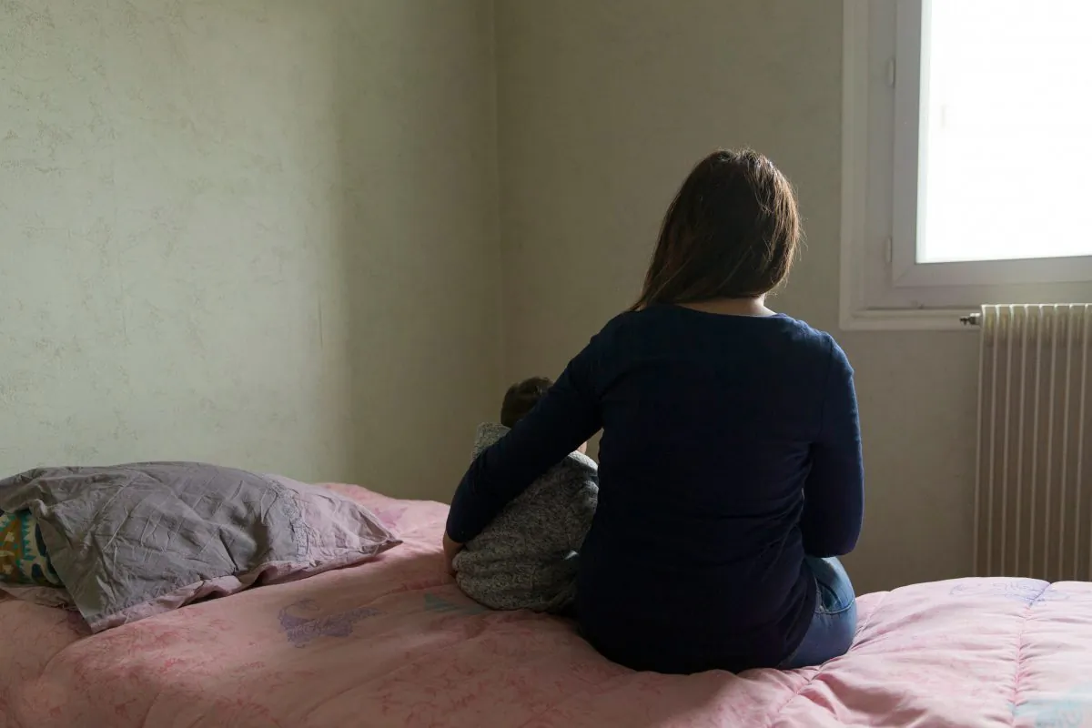 A mother and her child pose in a room in a temporary apartment of the Home association in Paris on November 22, 2016. (GEOFFROY VAN DER HASSELT/AFP/Getty Images)