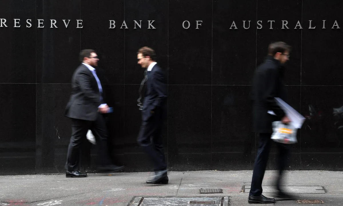 Office employees walk in front of the Reserve Bank of Australia in Sydney on Sept. 4, 2018. (Saeed Khan/AFP/Getty Images)